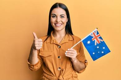asian student smile to you female look australian flag isolated yellow background 187077557